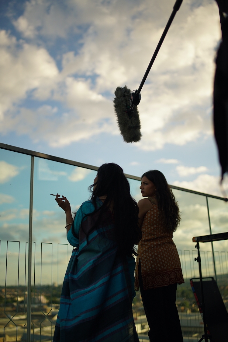 two actors having a cigarette between takes on a film set